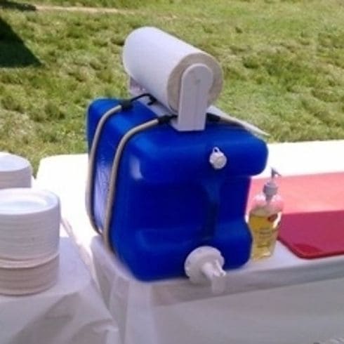 Plastic laundry detergent dispenser is being used as a hand wash station