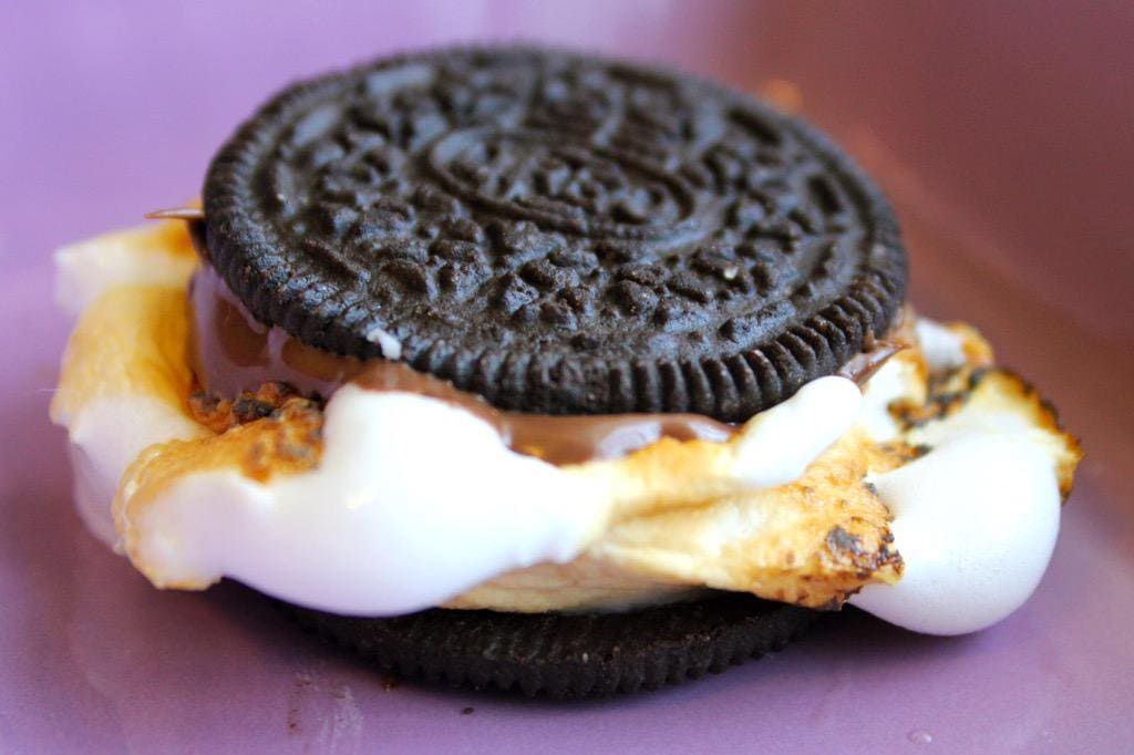 An Oreo with a melted marshmallow pouring off the sides