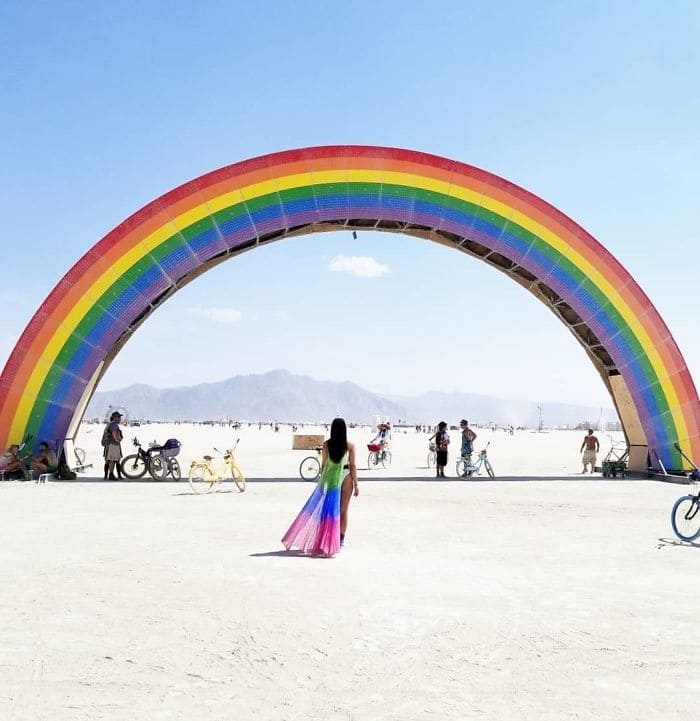Woman about to walk through a rainbow
