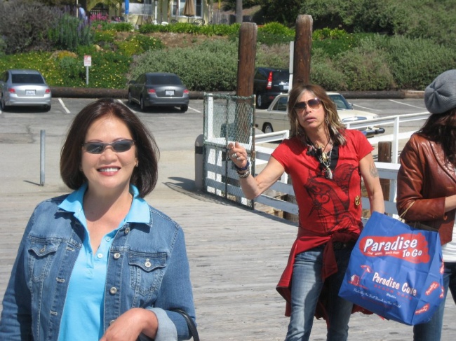 A woman and Steven Tyler in a parking lot 