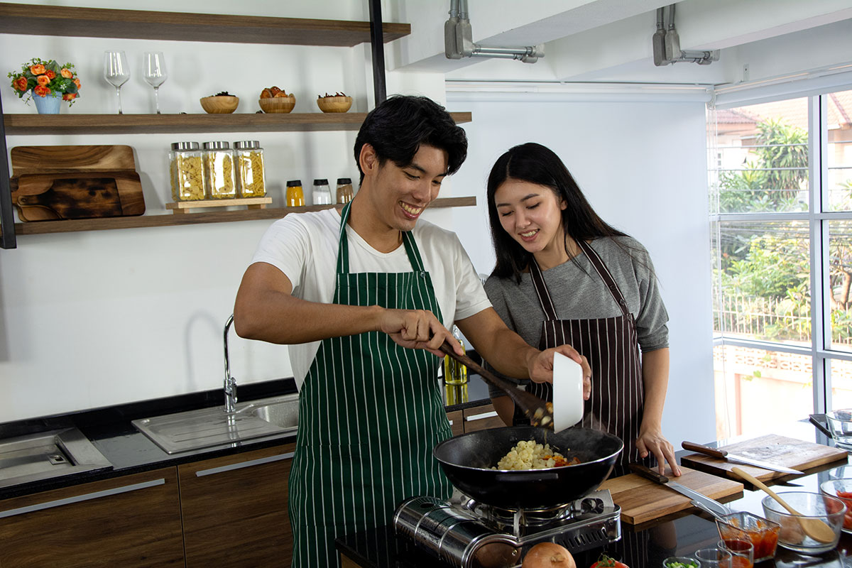 man and woman cooking