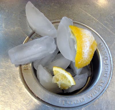 Ice and lemon pieces in the kitchen sink drain 