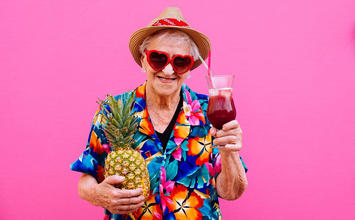 Elderly woman drinking a cocktail 
