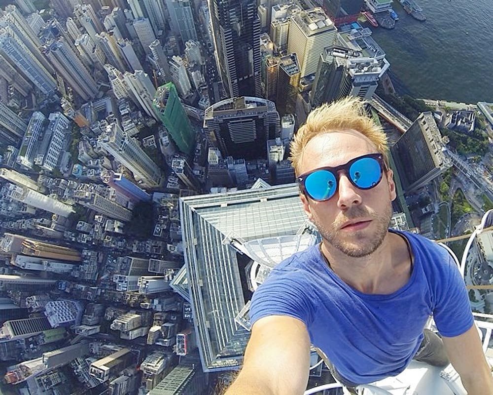Man taking a selfie on the top of a skyscraper