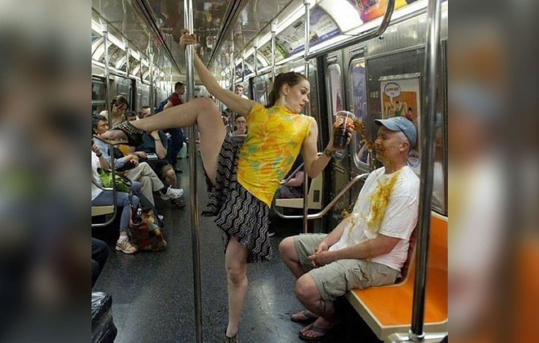 A Woman spilling her drink on a man on the subway 