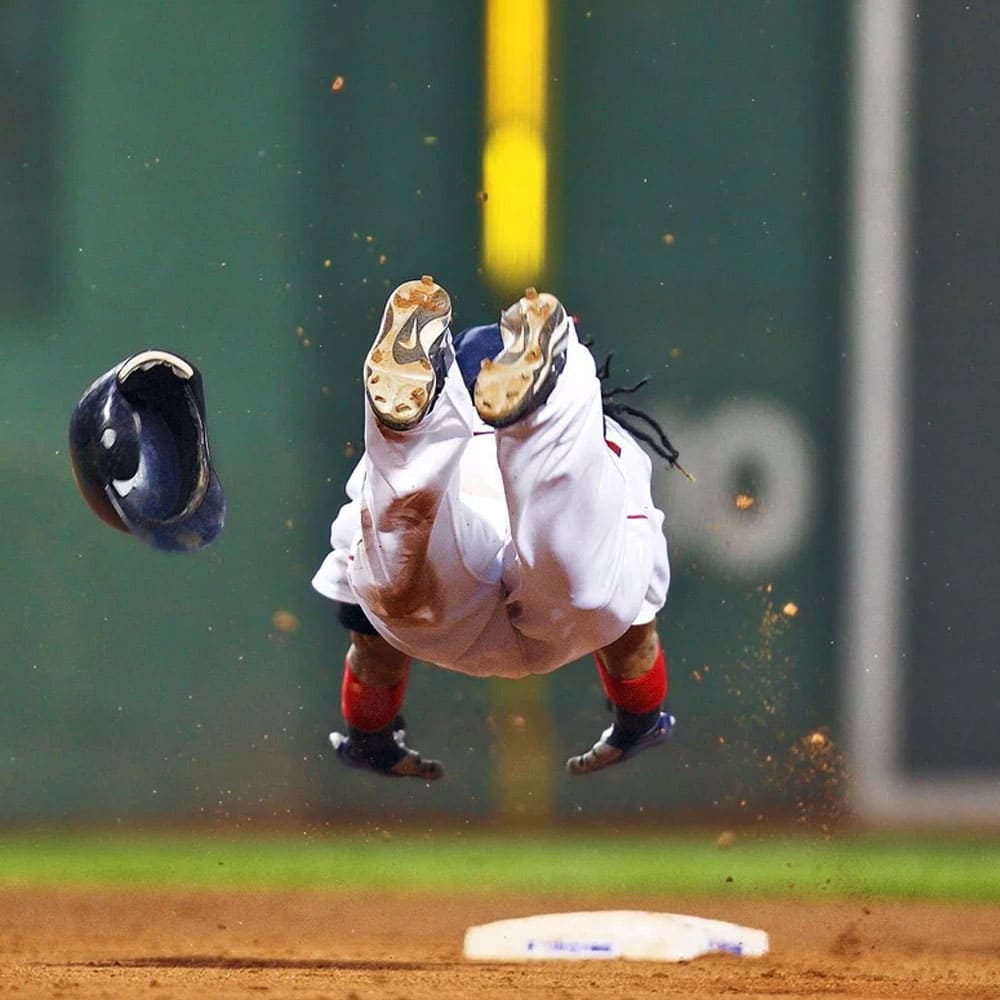 A baseball player diving at the base
