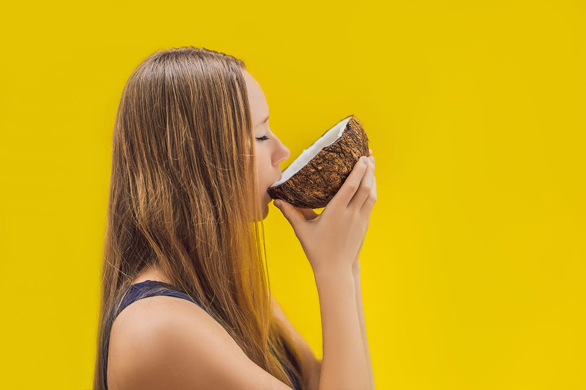 Girl drinking from a coconut