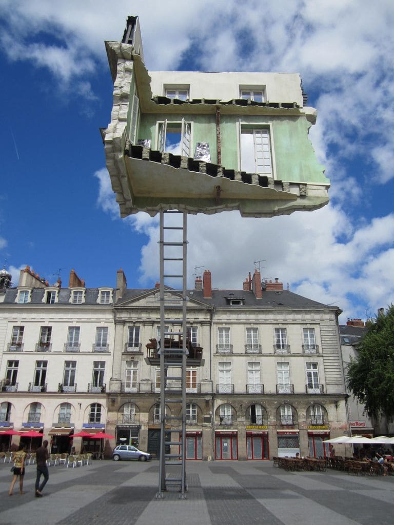 A House that appears to be levitating with a ladder reaching the ground