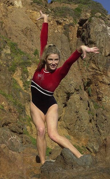 Heidi on a mountain wearing her gymnastics outfit 