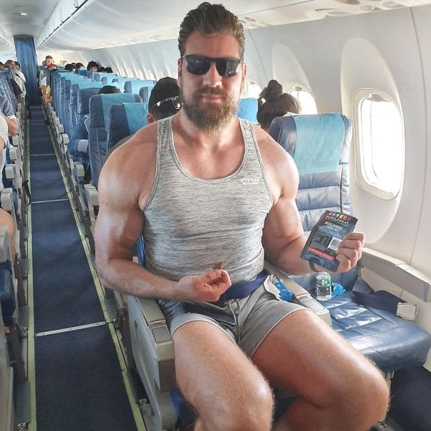 Large man barely fits in an airplane seat
