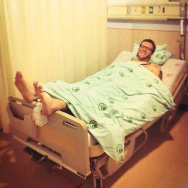 A tall man is too tall for the hospital bed