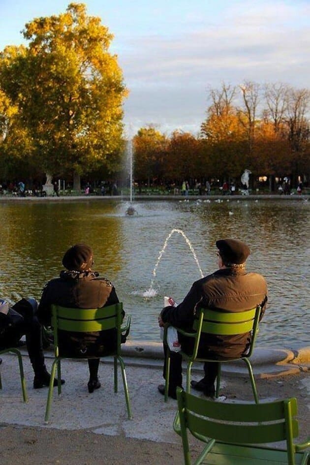 People sitting in front of a pond