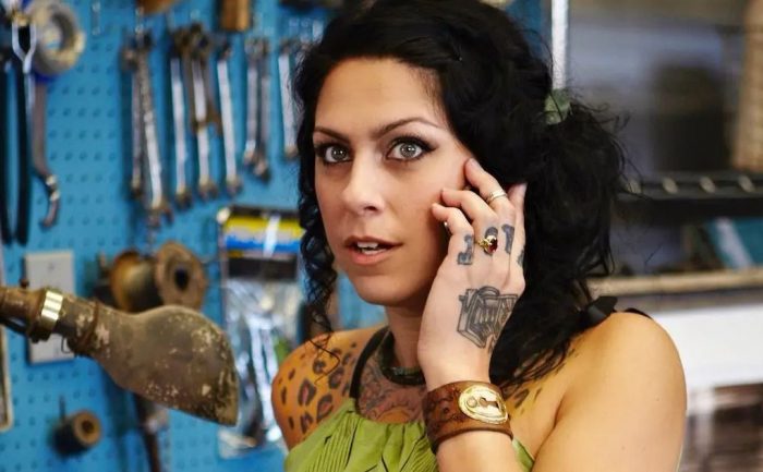 Danielle Colby on the phone in the garage 
