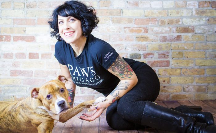Danielle Colby holding a dog’s paws 