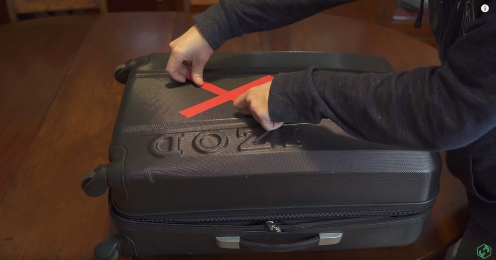 duct tape X on luggage 