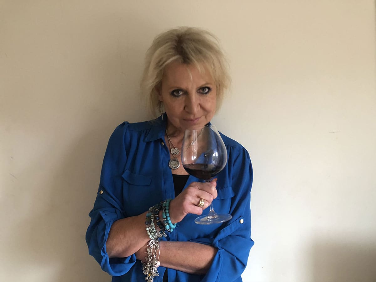 Angela Mount holding a glass of wine 