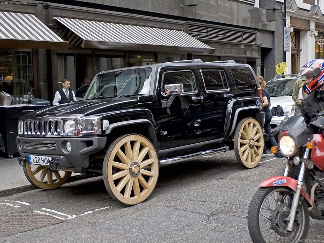 A black hummer with wooden wagon wheels