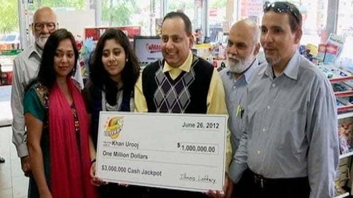 Photograph of lottery winner Urook Kahn with his family.