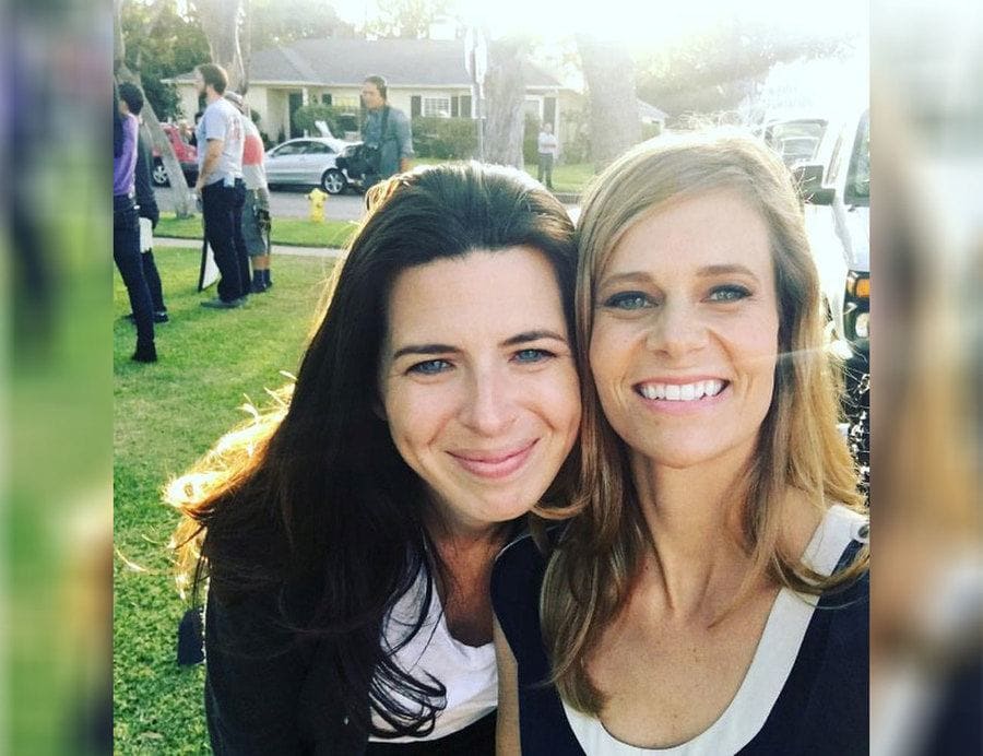 Heather Matarazzo and Heather Turman taking a selfie on a front lawn. 