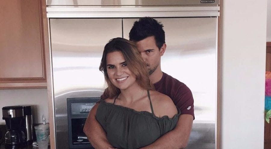 Taylor and Makena Lautner are hugging in their kitchen for a photograph.