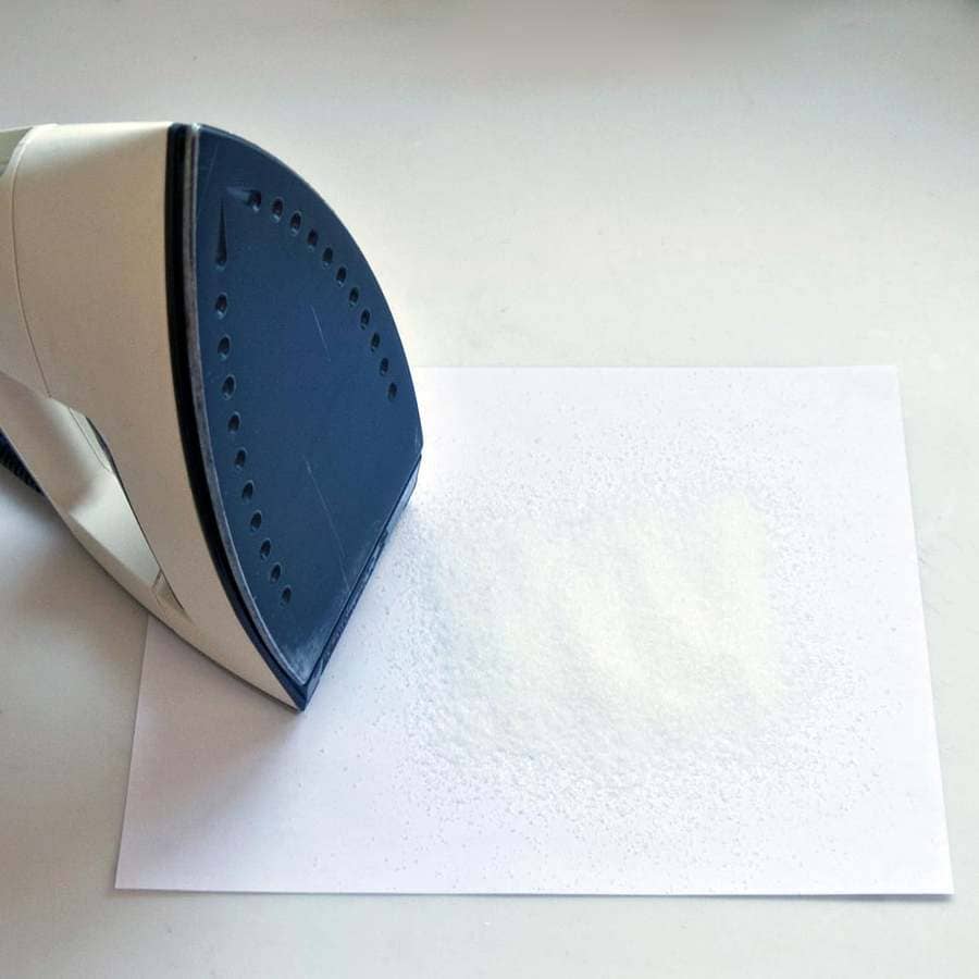 An Iron with salt on a paper.