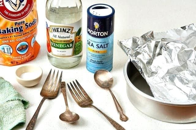Cleaning silverware with salt.