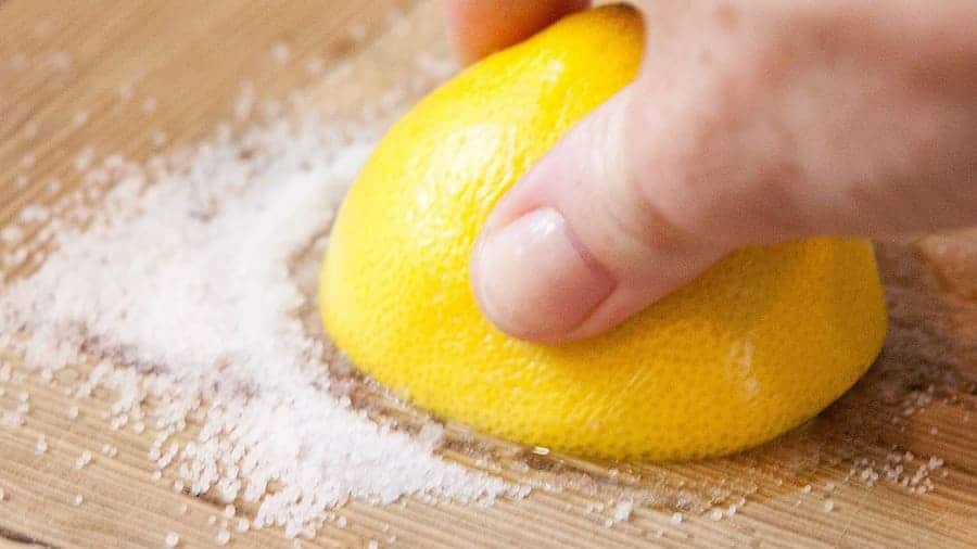 Cleaning a cutting board using salt.