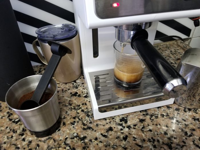 An espresso being brewed in a coffee machine.