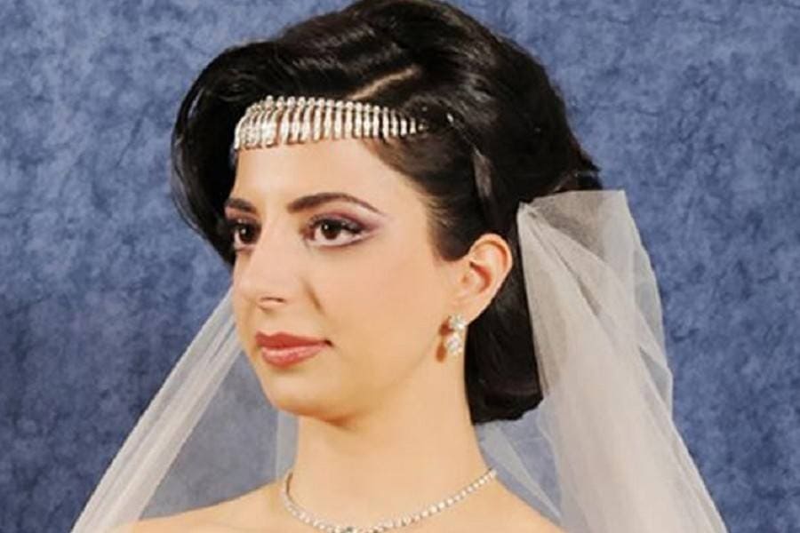 Hind Hariri at her wedding with a white vail on. 