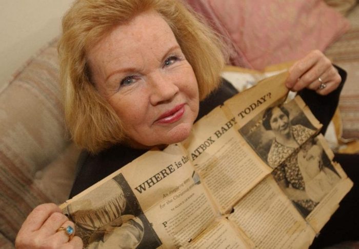 Sharon Elliot holding a newspaper 