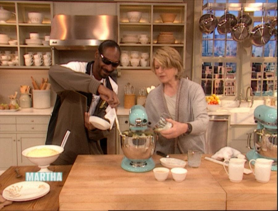 Snoop Dogg and Martha Stewart adding ingredients to a stand mixer during his first time on her show.
