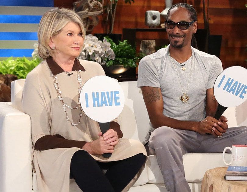 Martha and Snoop holding paddles that have ‘I Have’ written across them on the Ellen DeGeneres show. 