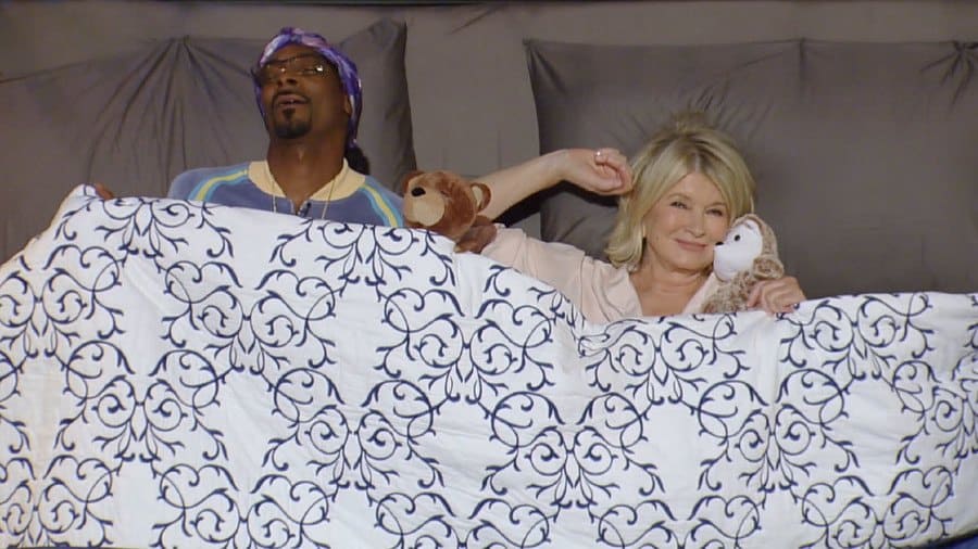 Martha and Snoop standing next to a mattress in an intro to their show. 