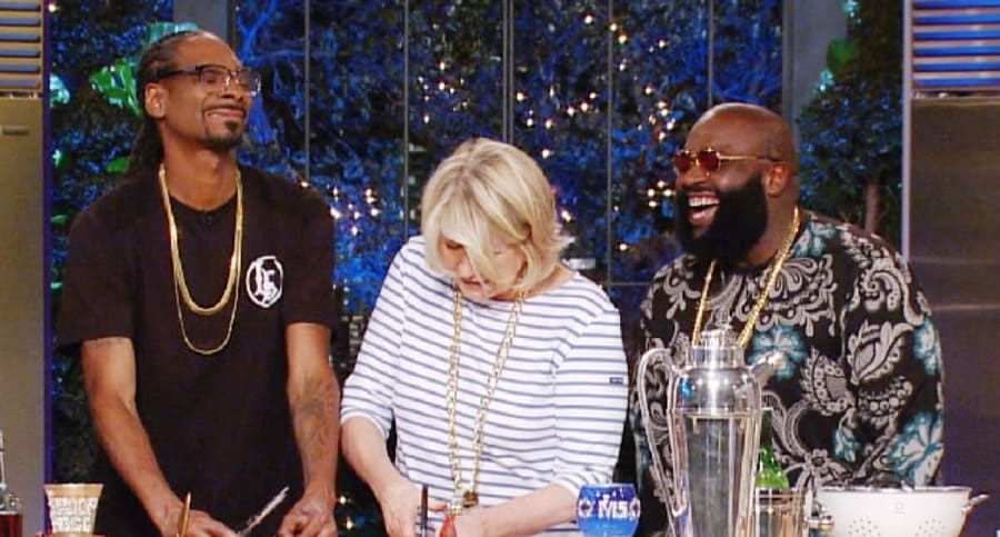 Snoop Dogg, Martha Stewart, and Rick Ross laughing together while cooking. 