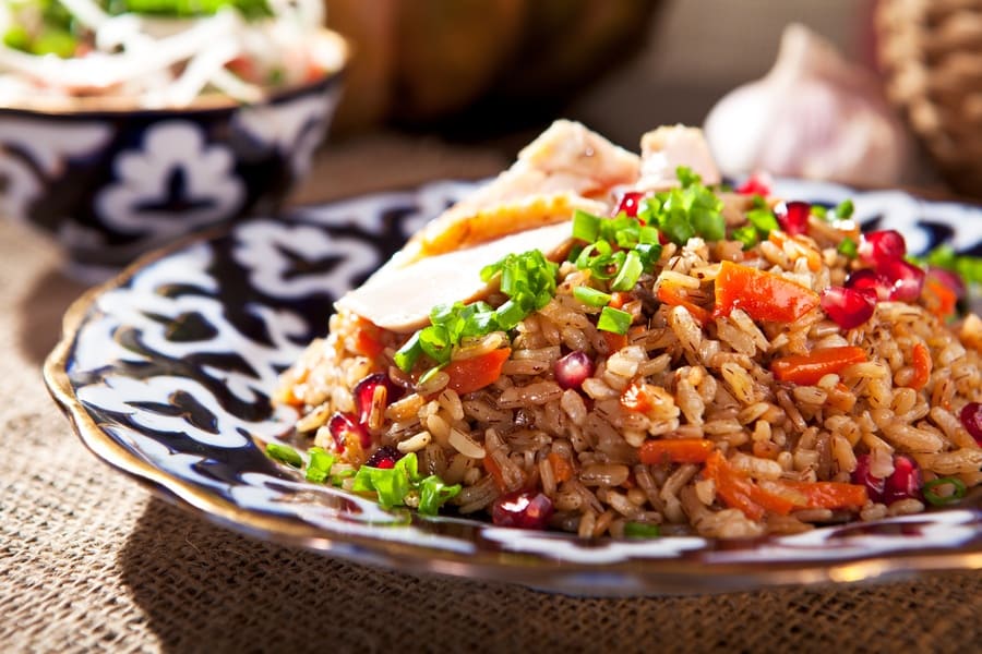 Rice pilaf with vegetables, pomegranate, and onions. 