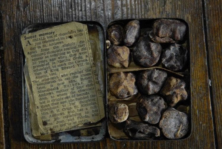 Photograph of the oldest chocolates found with a small newspaper clipping labeled Sweet memory. 