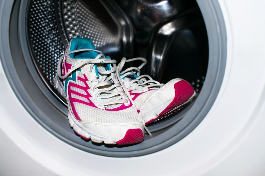 White and pink sneakers wash in the washer (automatic washing machine)