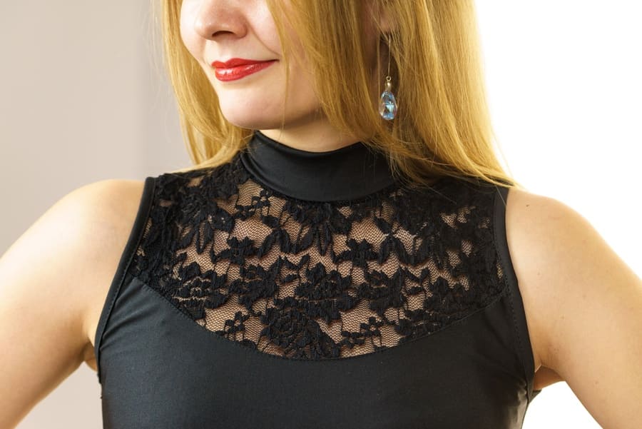 woman wearing a black top with lace detail on chest