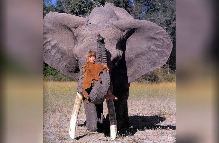 Tippy as a child hugging an elephant 