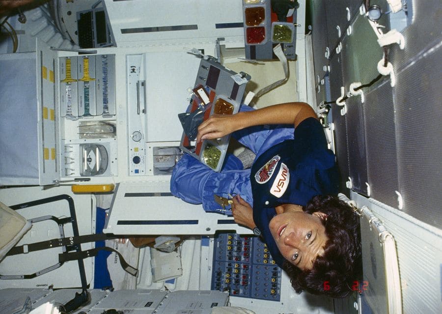 Sally Ride having a meal on board the space shuttle Challenger during the STS-41-G mission in 1984.