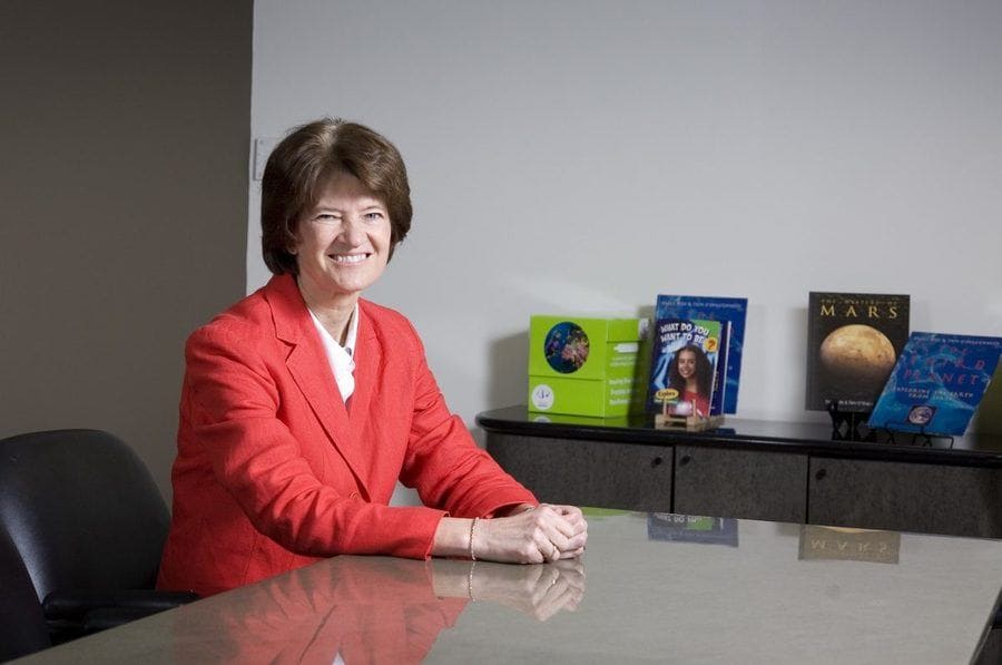 Sally Ride is sitting with some of the books written by her and Tam O’Shaughnessy in 2007.
