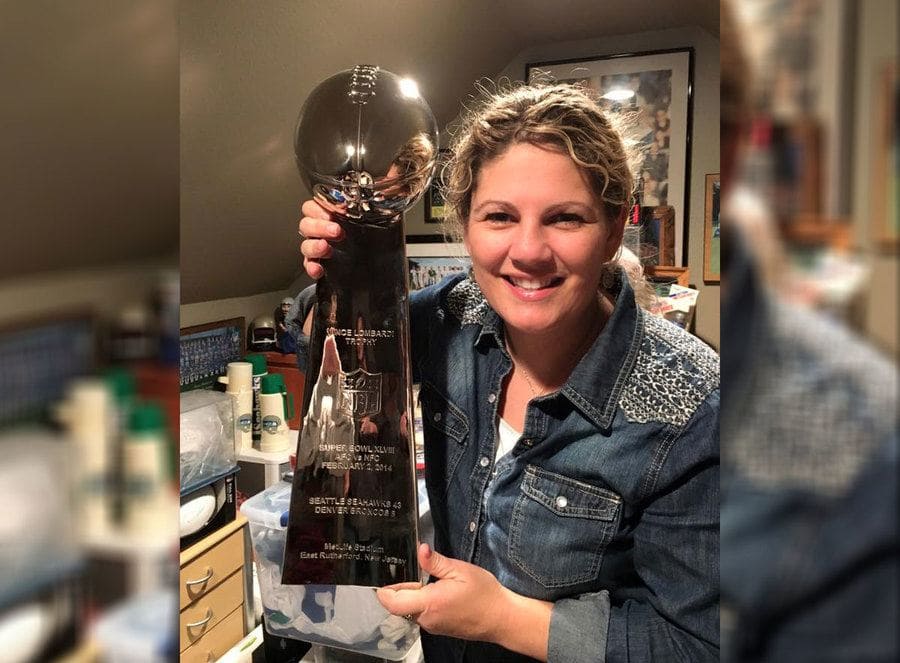 Summer Worden holding The Vince Lombardi Trophy
