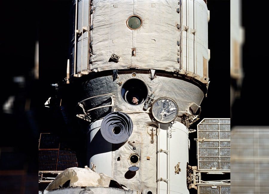 Valeri Polyakov watches from Mir as the Space Shuttle Discovery 