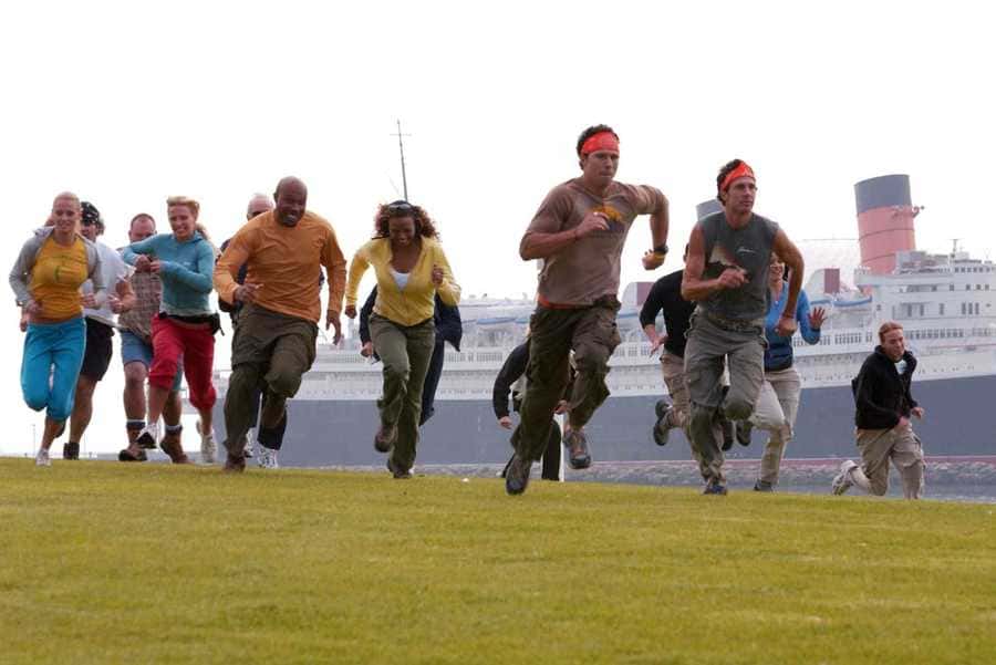 The Amazing Race contestants running at the start of a mission