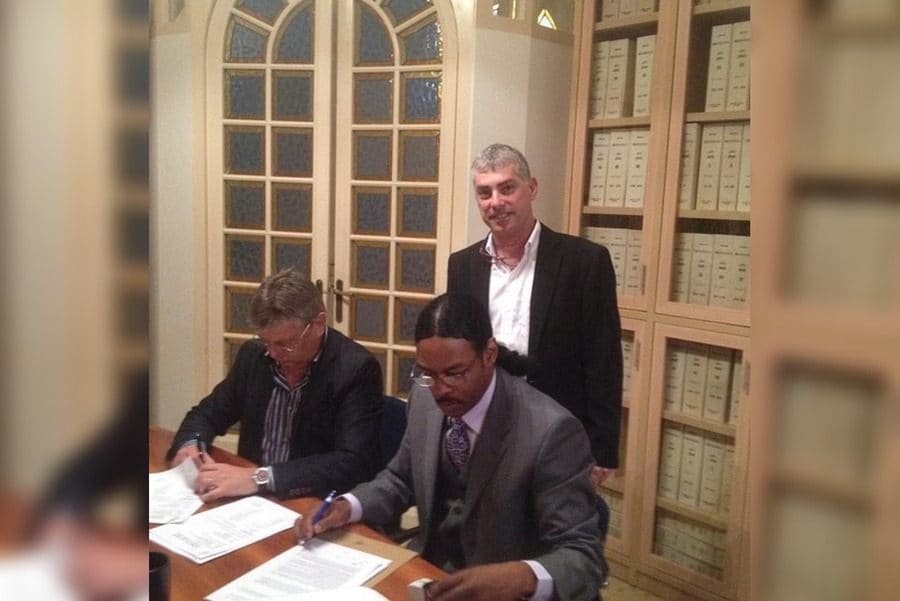 Isaac Jr. signing his agreement 