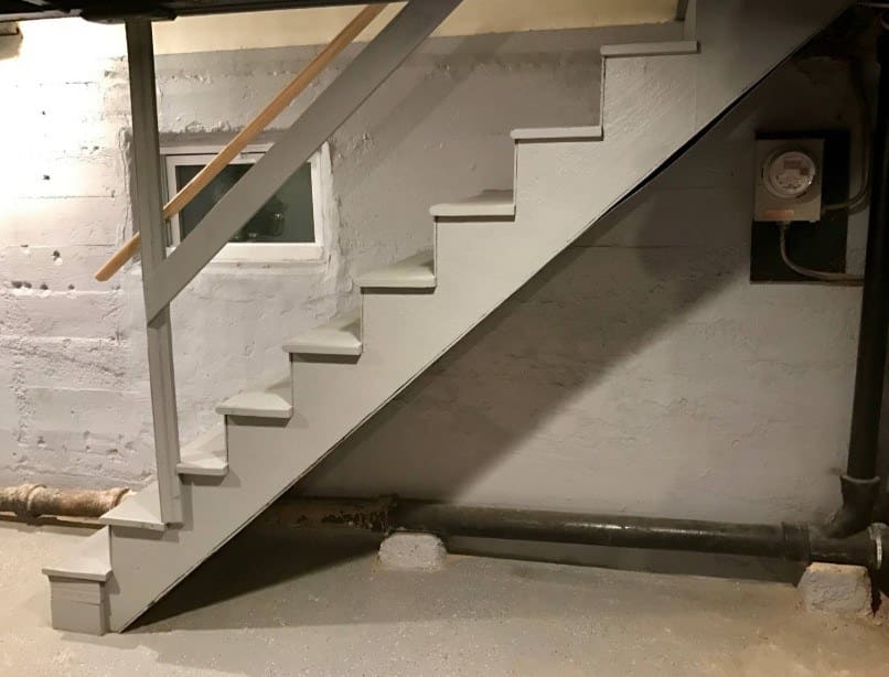 The basement is empty with the steps going down the side of the wall before they started work on it