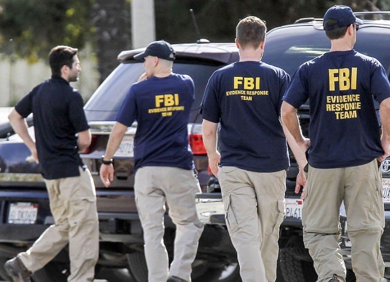 A few FBI evidence response team members are walking around 