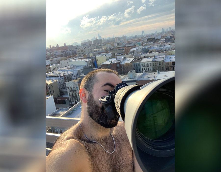 Jeremy Cohen is taking a selfie of himself with a large Sony camera. 