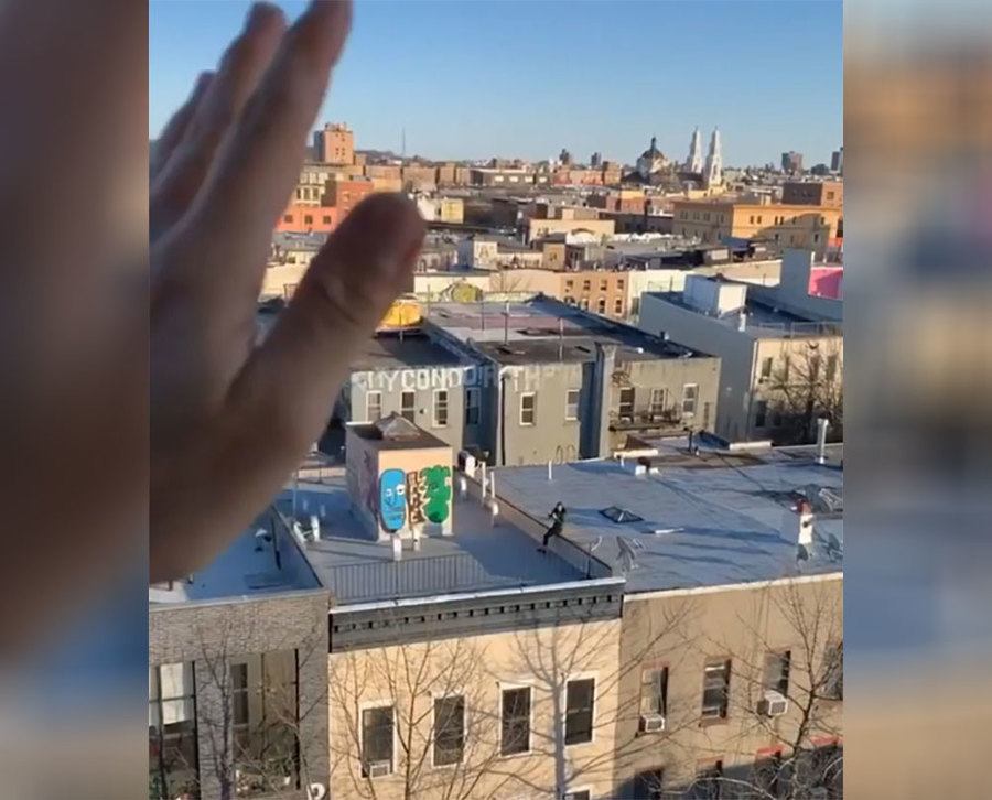 Jeremy is waving at Tori from his balcony. 