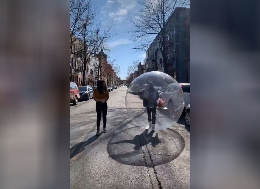 Jeremy and Tori are walking in the middle of the street while Jeremy is in the bubble.